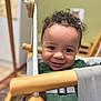 Wayland joined the competition — help win amazing prizes! baby_swing, child, closeup, curly_hair, cute, face, furniture, green_sweater, happy, home, indoor, infant, person, play, rope, seat, smiling, toddler, wooden_frame, young_child