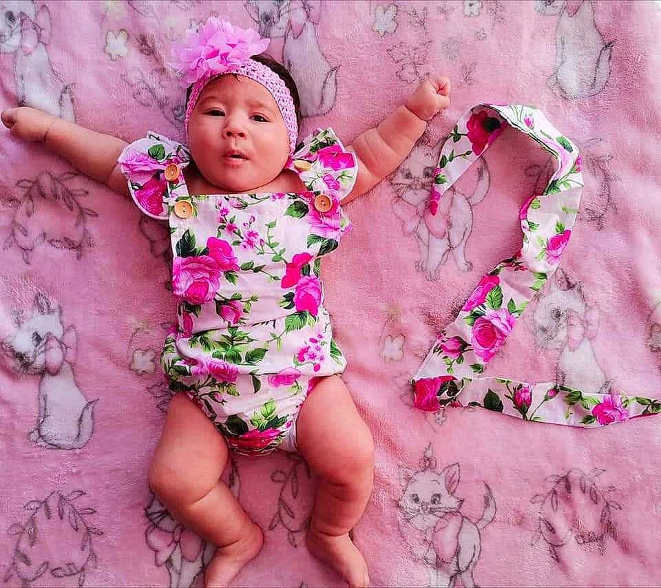 Solenzara participe au concours pour gagner de l'argent avec cette photo : baby, baby_toddler_clothing, barefoot, child, child_model, flower, fun, hair_accessory, happy, headgear, headwear, pattern, person, photo_shoot, photography, pink, plant, product, skin, smile