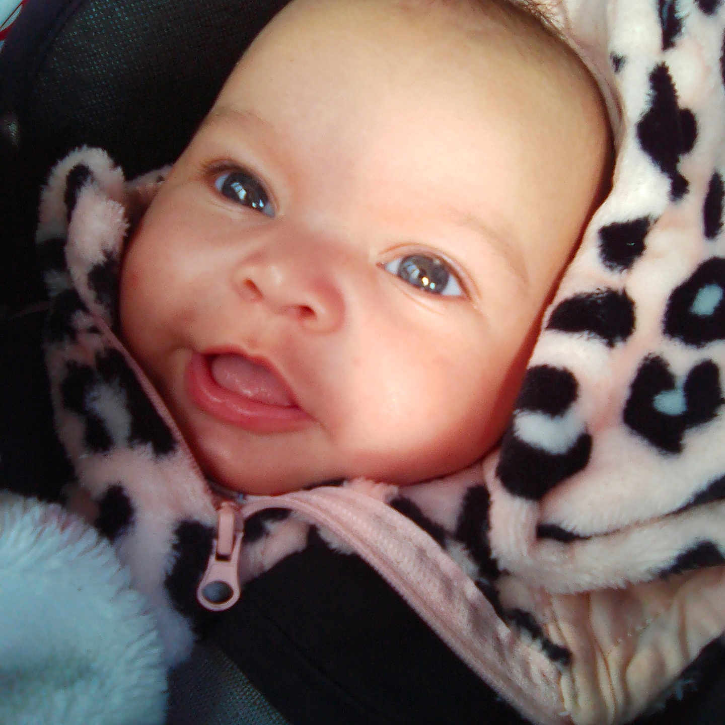 Renea Mae is registered to the contest to win money with this photo: baby, bonnet, clothing, coat, face, happy, hat, head, hood, hoodie, jacket, knitwear, laughing, newborn, person, photography, portrait, smile, sweater, sweatshirt