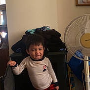 Matías joined the competition — help win amazing prizes! barefoot, child, clothing, cozy, expression, family_photos, fan, furniture, heater, home, indoor, leaning, pajamas, person, plaid_pants, portrait, room, smile, standing, wall