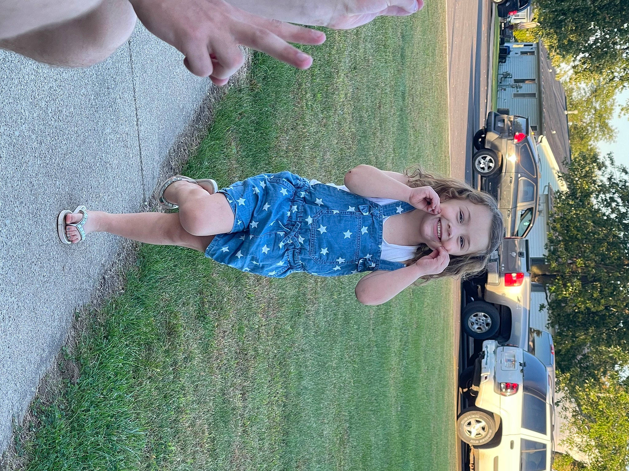 Addelyn is registered to the contest to win money with this photo: automotive_exterior, automotive_lighting, car, electric_blue, grass, green, hand, joy, leisure, light, line, person, plant, rolling, summer, thigh, tire, toddler, tree, vehicle