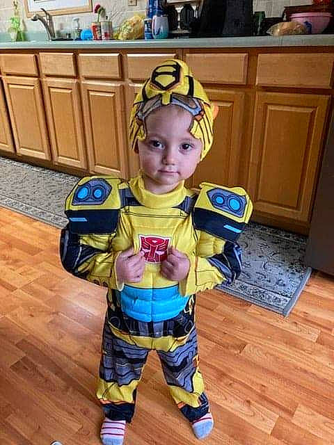 Brentlee is registered to the contest to win money with this photo: baby, baby_toddler_clothing, blue, cabinetry, chair, child, fictional_character, flooring, fun, happy, hardwood, headwear, laminate_flooring, person, personal_protective_equipment, play, room, standing, toddler, wood