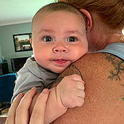 Cullen is registered to the contest to win money with this photo: adult, baby, bonding, child, closeup, cute, expression, face, family, hand, holding, human, human_hand, indoor, infant, love, person, shoulder, skin, tattoo