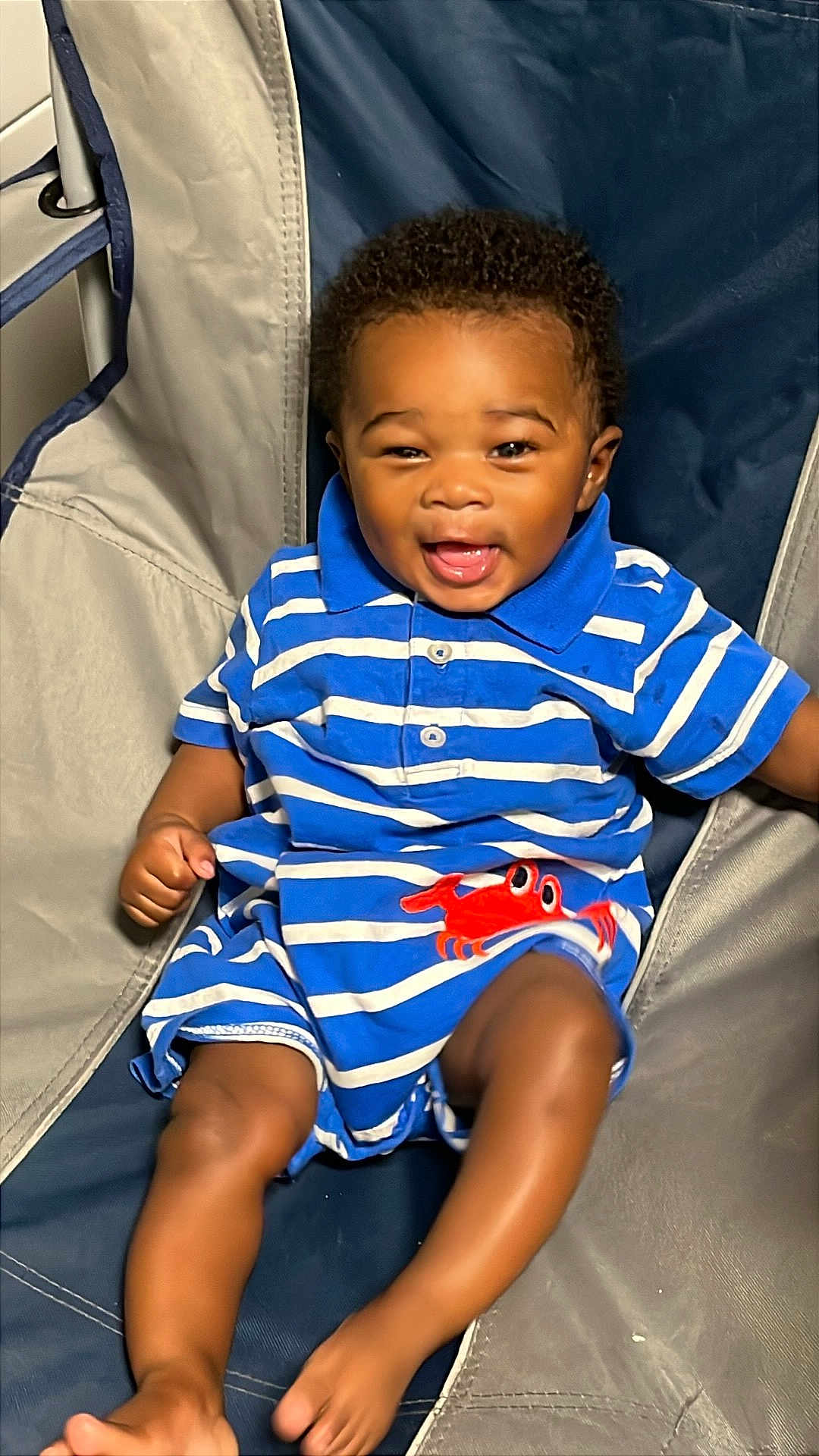 Kason joined the competition — help win amazing prizes! baby, child, smiling, striped_clothing, blue, red_crab, sitting, chair, happy, cute, infant, portrait, indoor, face, legs, feet, shorts, collar, buttoned_shirt, skin