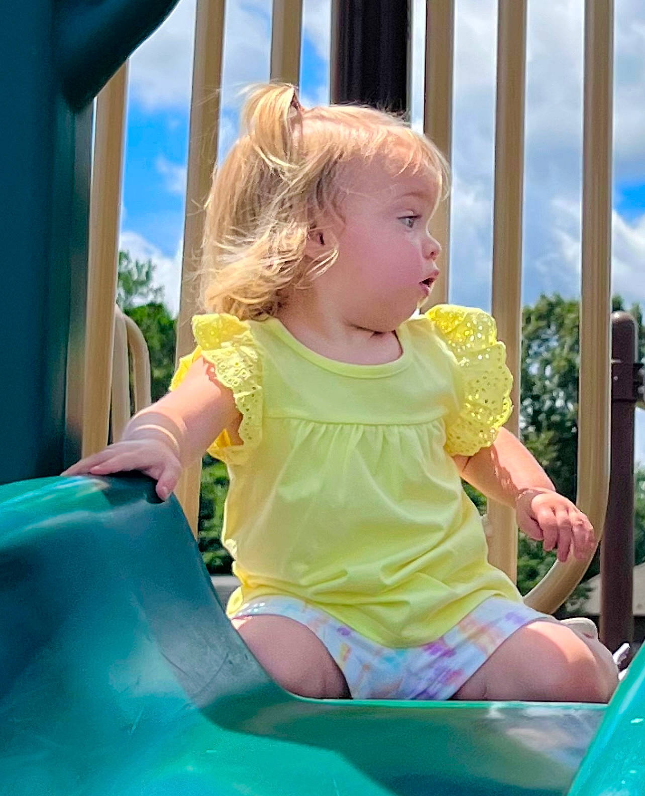 Adalyn joined the competition — help win amazing prizes! baby_toddler_clothing, blue, child, chute, city, cloud, fun, grass, green, happy, leisure, outdoor_play_equipment, person, play, playground, playground_slide, recreation, sitting, sky, toddler