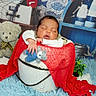 baby, sleeping, bucket, red_blanket, blue_teddy_bear, teddy_bear, soft_rug, plant, decor, wooden_box, rope, blue_background, white_clothing, child, infant, portrait, cozy, cute, indoor, photography
