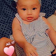 Lilly-Ann joined the competition — help win amazing prizes! baby, infant, child, portrait, smiling, bow_headband, striped_outfit, romper, sitting, indoors, couch, blanket, patterned_background, close_up, face, eyes, hands, legs, heart_sticker, date_stamp