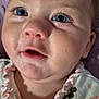 Haylee is registered to the contest to win money with this photo: baby, blanket, blue_eyes, child, close_up, clothing, curious_expression, cute, face, floral_pattern, head, indoors, infant, mouth_open, person, portrait, ruffles, skin, soft_texture, young