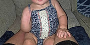 Haylee is registered to the contest to win money with this photo: baby, blur, casual, child, clothing, couch, eyes, fabric, face, foot, hand, indoor, infant, legs, living_room, pattern, person, romper, seated, skin