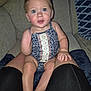 baby, blur, casual, child, clothing, couch, eyes, fabric, face, foot, hand, indoor, infant, legs, living_room, pattern, person, romper, seated, skin