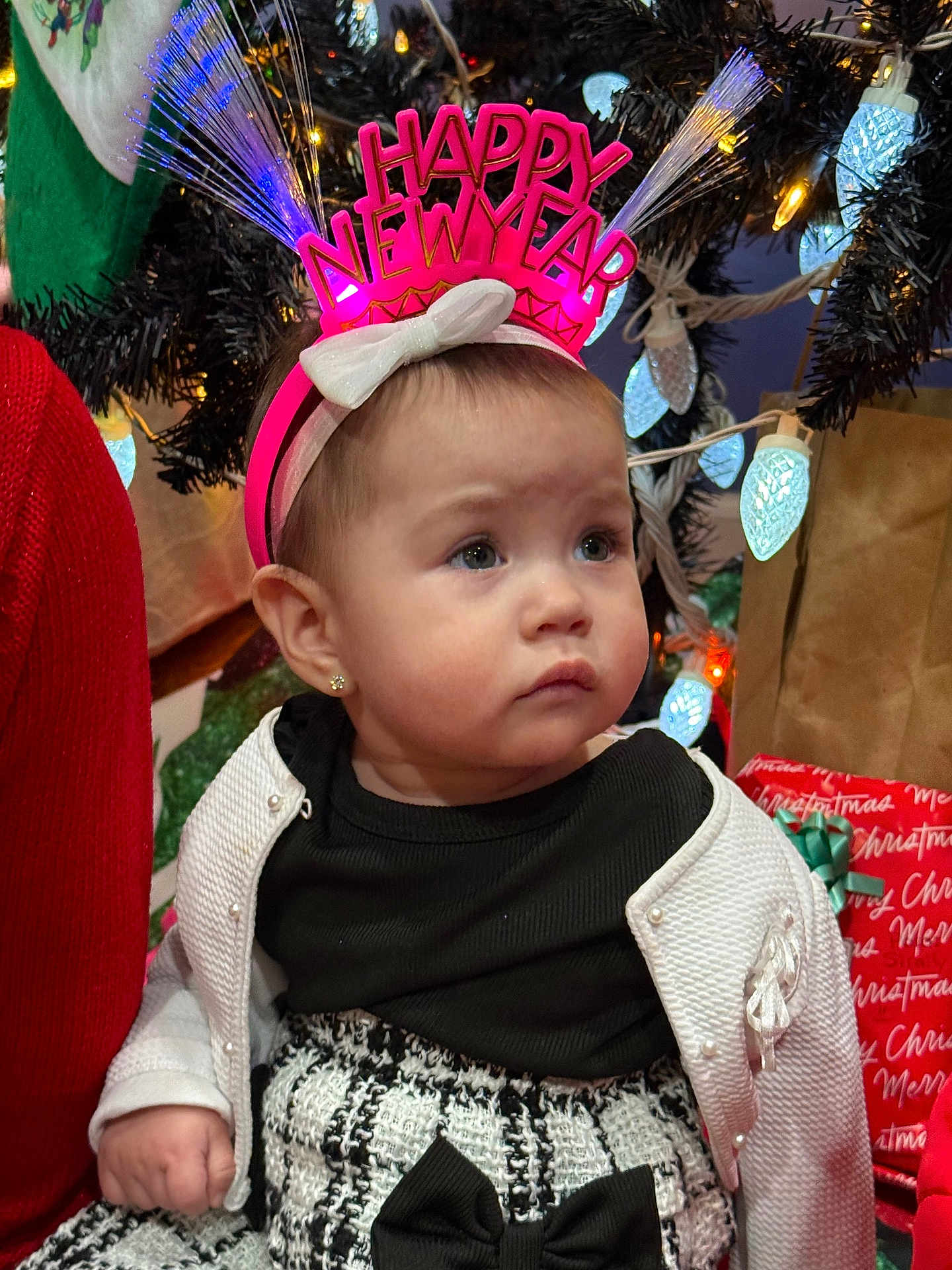 Ziraili joined the competition — help win amazing prizes! baby, bow, cardigan, child, christmas_lights, christmas_tree, cute, dress, earring, face, festive, happy_new_year, headband, holiday, indoor, ornament, portrait, present, sitting, toddler