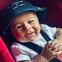 Nassim Djellouah a rejoint le concours — aidez-le/la à gagner de superbes lots ! baby, infant, smile, face, hat, bucket_hat, bracelet, white_shirt, car_seat, red_car_seat, hands, cute, happy, child, portrait, baby_clothing, close_up, young_child, skin, person