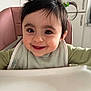 baby, smiling, high_chair, pigtails, green_hair_clip, bib, indoor, kitchen, child, cute, face, person, happy, young_child, feeding, infant, clothing, seat, portrait, home