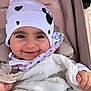 baby, smiling, hat, blanket, stroller, child, face, clothing, cute, warm, comfort, infant, pink, white, pattern, mickey_mouse, heart, happy, closeup, portrait