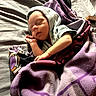baby, sleeping, blanket, bed, purple, hoodie, controller, game_controller, infant, resting, cozy, soft, child, peaceful, portrait, indoor, fabric, cute, tiny, relaxation