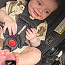 Lyric is registered to the contest to win money with this photo: baby, infant, child, smiling, car_seat, harness, portrait, indoors, vehicle, sitting, lying_down, brown_hair, face, eyes, hands, feet, clothing, safety_label, phone_screenshot, happy