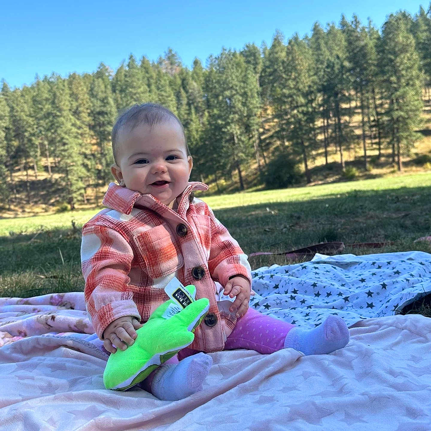 Delilah joined the competition — help win amazing prizes! baby, babylaughing, clothing, face, grass, happy, head, hosiery, nature, outdoors, pants, park, person, photography, plant, portrait, sitting, sock, tree, vegetation