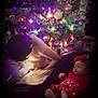 baby, book, celebration, child, christmas_tree, cozy, decorations, family, festive, headband, holiday, holiday_season, indoor, lights, ornaments, portrait, reading, red_dress, sleeping, soft_lighting