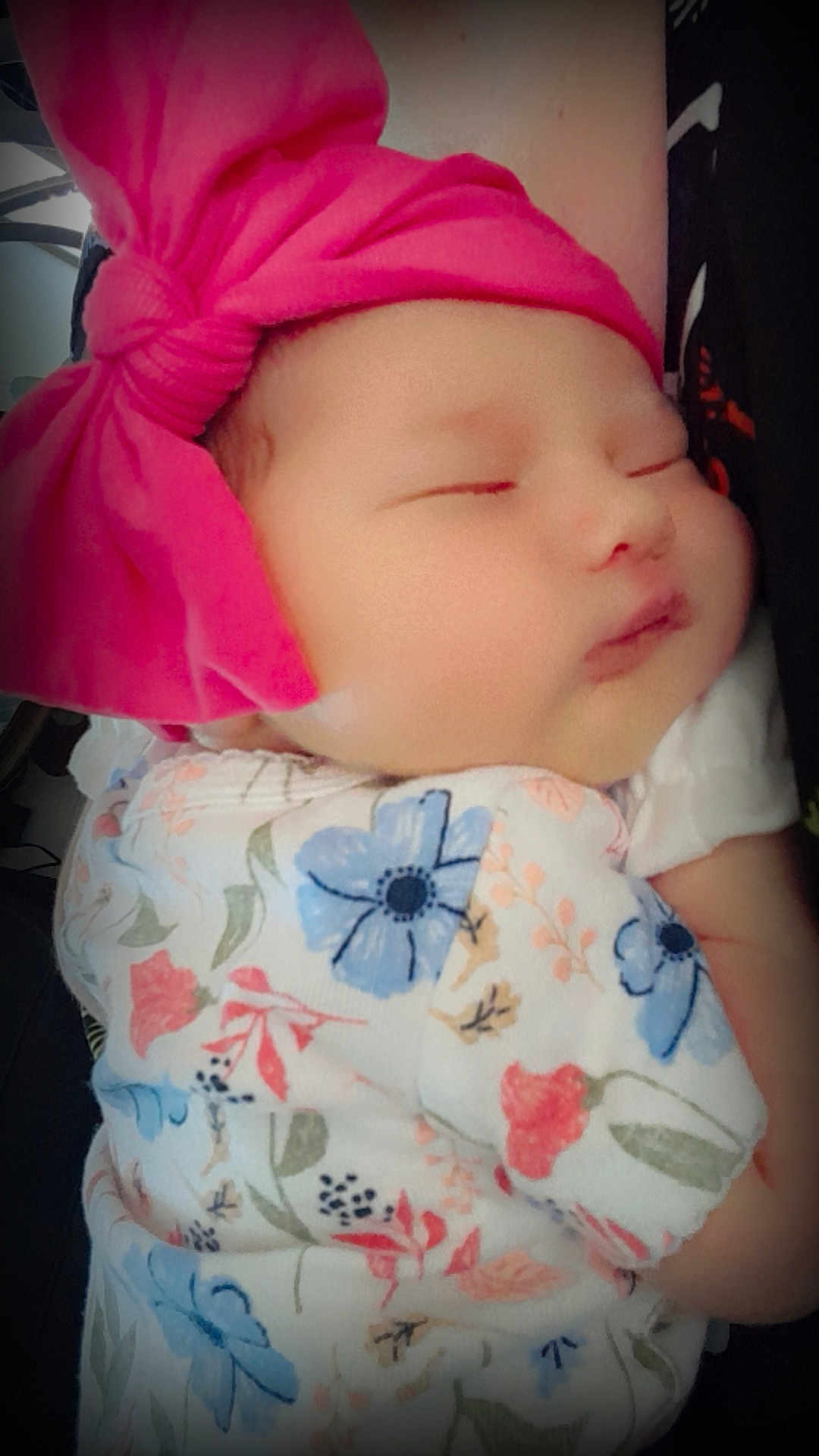 Eva is registered to the contest to win money with this photo: baby, infant, sleeping, headband, pink_bow, floral_clothing, closeup, peaceful, soft_skin, child, cute, portrait, toddler, resting, newborn, person, adorable, indoors, comfort, calm