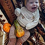 baby, infant, smiling, headband, blanket, pumpkin, pine_cone, thanksgiving, clothing, knit_booties, striped_pants, fall, autumn, cozy, patterned_blanket, celebration, cute, happy, holiday, sitting