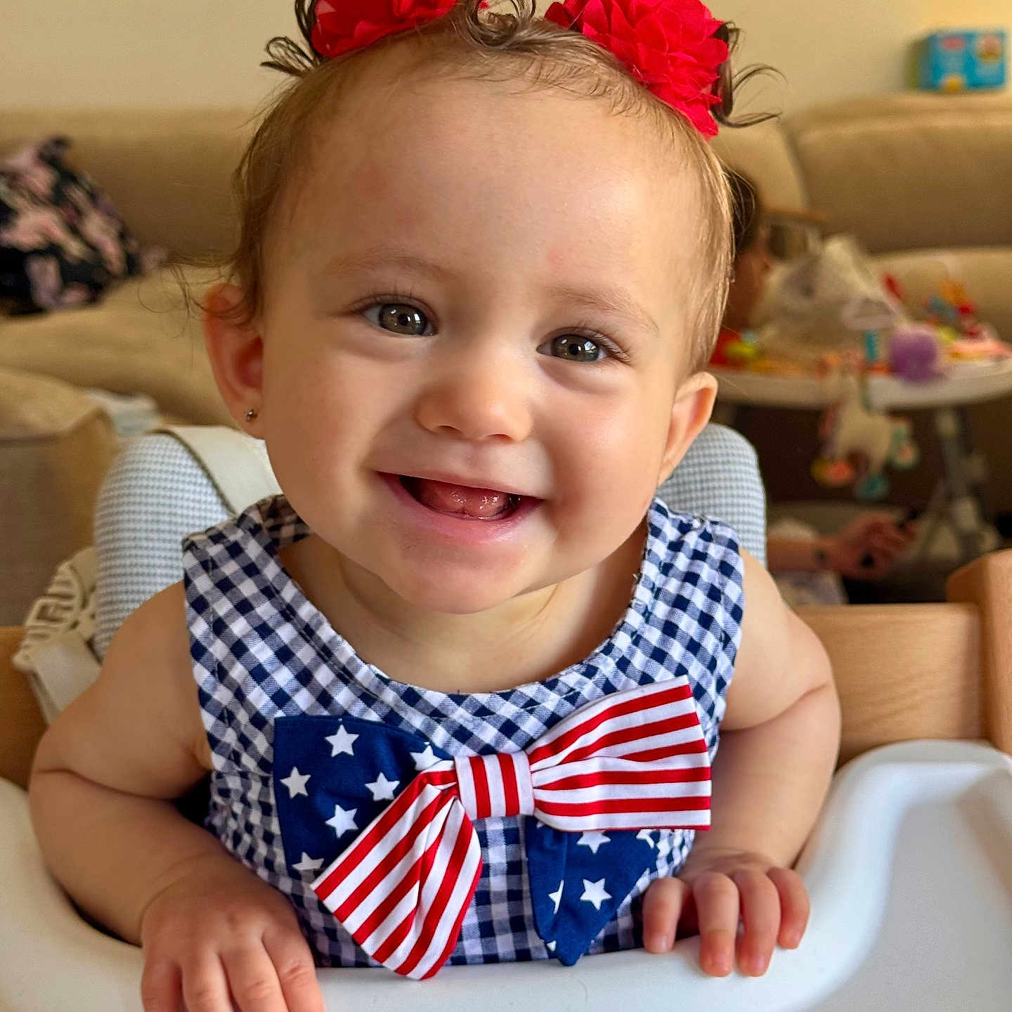 Arya joined the competition — help win amazing prizes! baby, bow, cheerful, child, cute, dress, eyes, face, furniture, hair_accessory, hand, happy, high_chair, indoor, infant, person, portrait, red_flower, skin, smiling