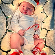Lincoln is registered to the contest to win money with this photo: baby, infant, sleeping, santa_hat, candy_cane, christmas_lights, white_onesie, red_socks, holiday, festive, blanket, closeup, cute, celebration, newborn, soft_texture, holiday_theme, indoors, cozy, child