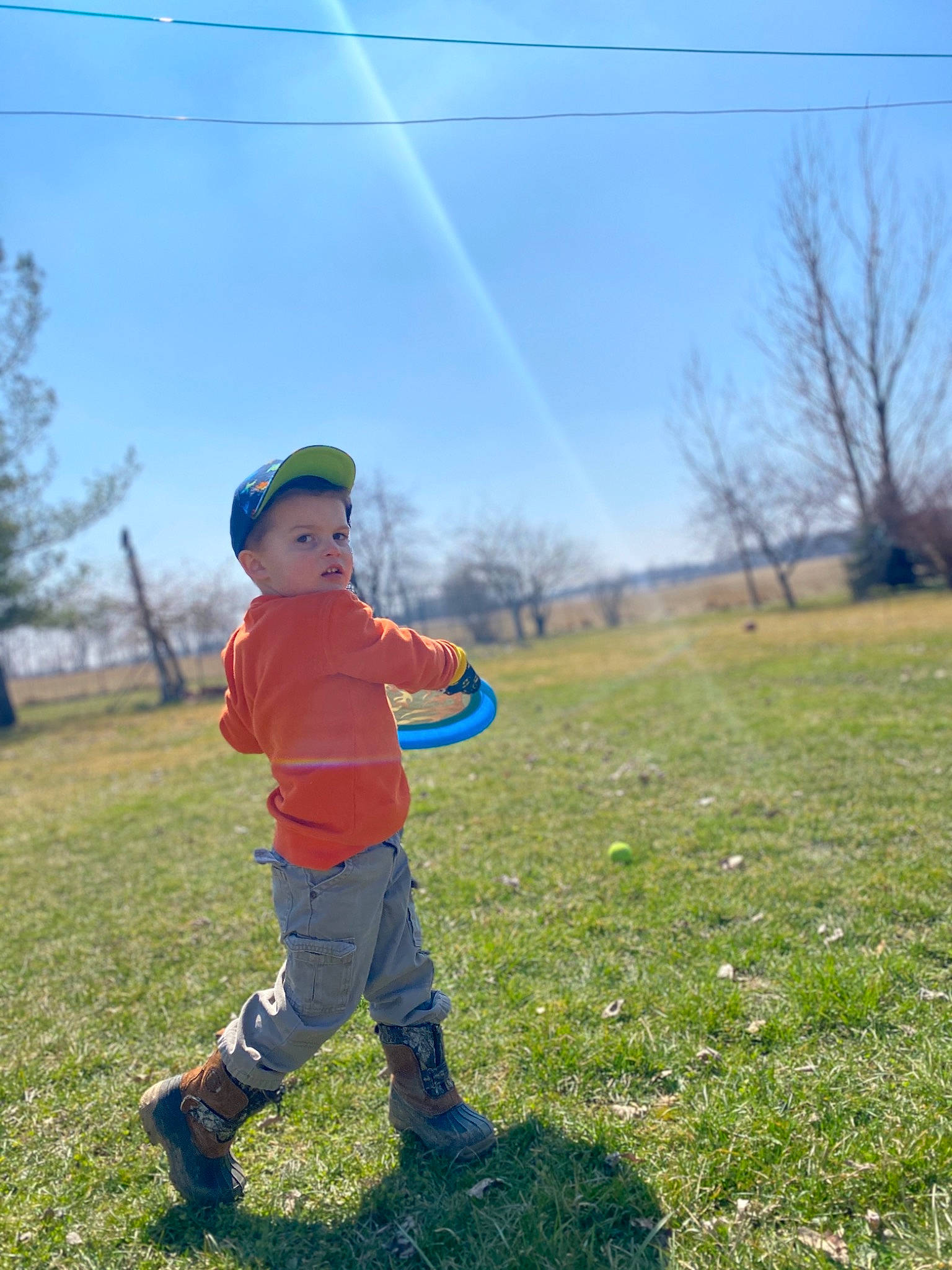 Ian is registered to the contest to win money with this photo: child, fun, grass, grassland, happy, lawn, meadow, pasture, people_in_nature, person, plant, play, sky, spring, standing, toddler, tree, vacation