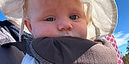 Paisley joined the competition — help win amazing prizes! baby, child, infant, sun_hat, baby_carrier, outdoor, blue_sky, hand, face, person, clothing, closeup, daylight, cute, skin, adult, parent, nature, portrait, headwear