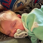 Paisley joined the competition — help win amazing prizes! baby, sleeping, pacifier, blanket, person, head, face, clothing, indoor, rest, comfort, child, closeup, soft, peaceful, nap, cuddle, human, portrait, infant