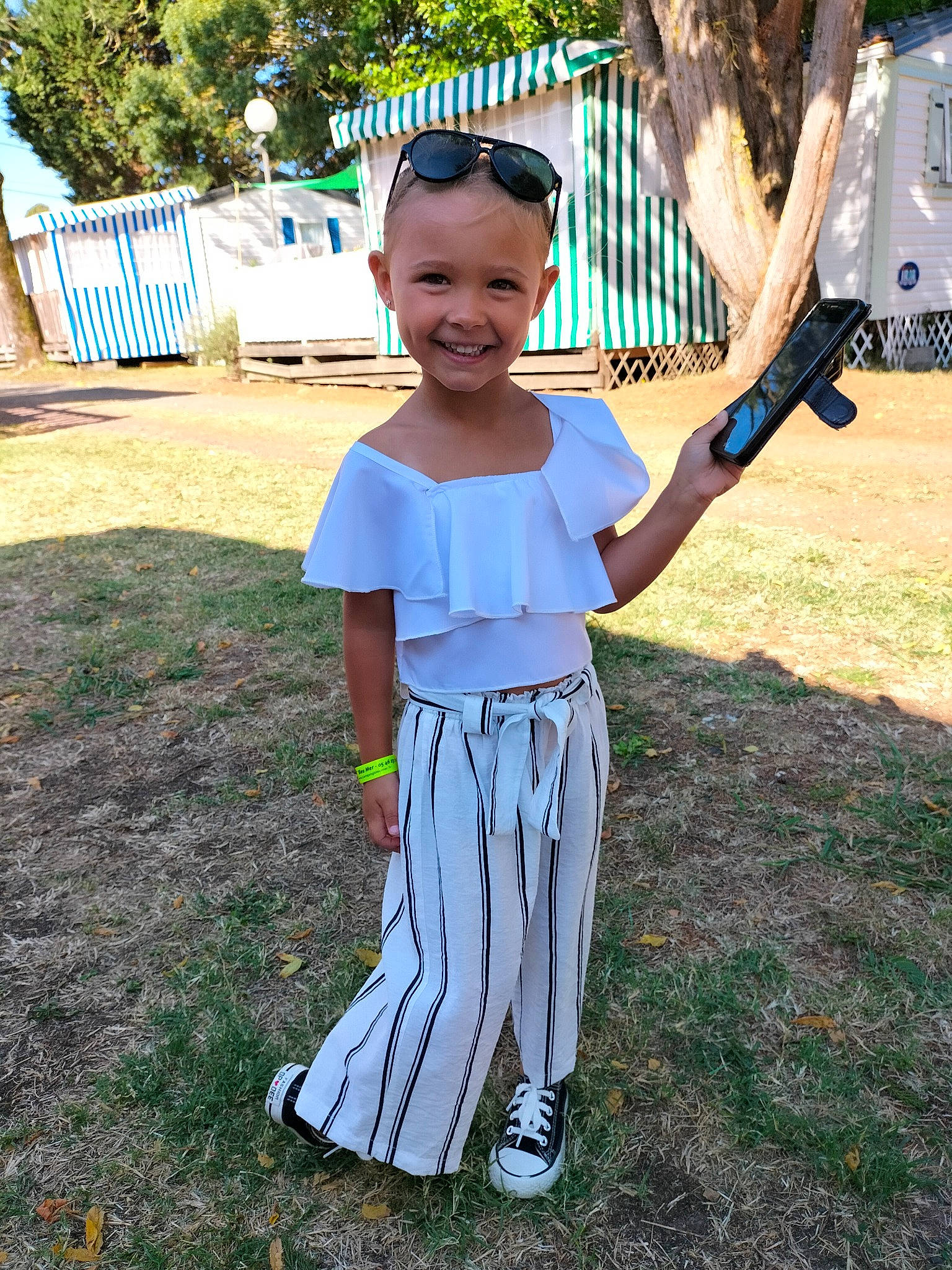 Kimberly participe au concours pour gagner de l'argent avec cette photo : cool, costume, electric_blue, fun, grass, happy, headwear, joy, leisure, pajamas, pattern, person, personal_protective_equipment, plant, recreation, sleeve, smile, soil, t_shirt, toddler