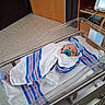 newborn, baby, hospital, bassinet, blanket, pacifier, medical_equipment, floor, wooden_cabinet, person, infant, wrapped, bed, indoors, patient, cute, peaceful, hospital_room, healthcare, sleeping