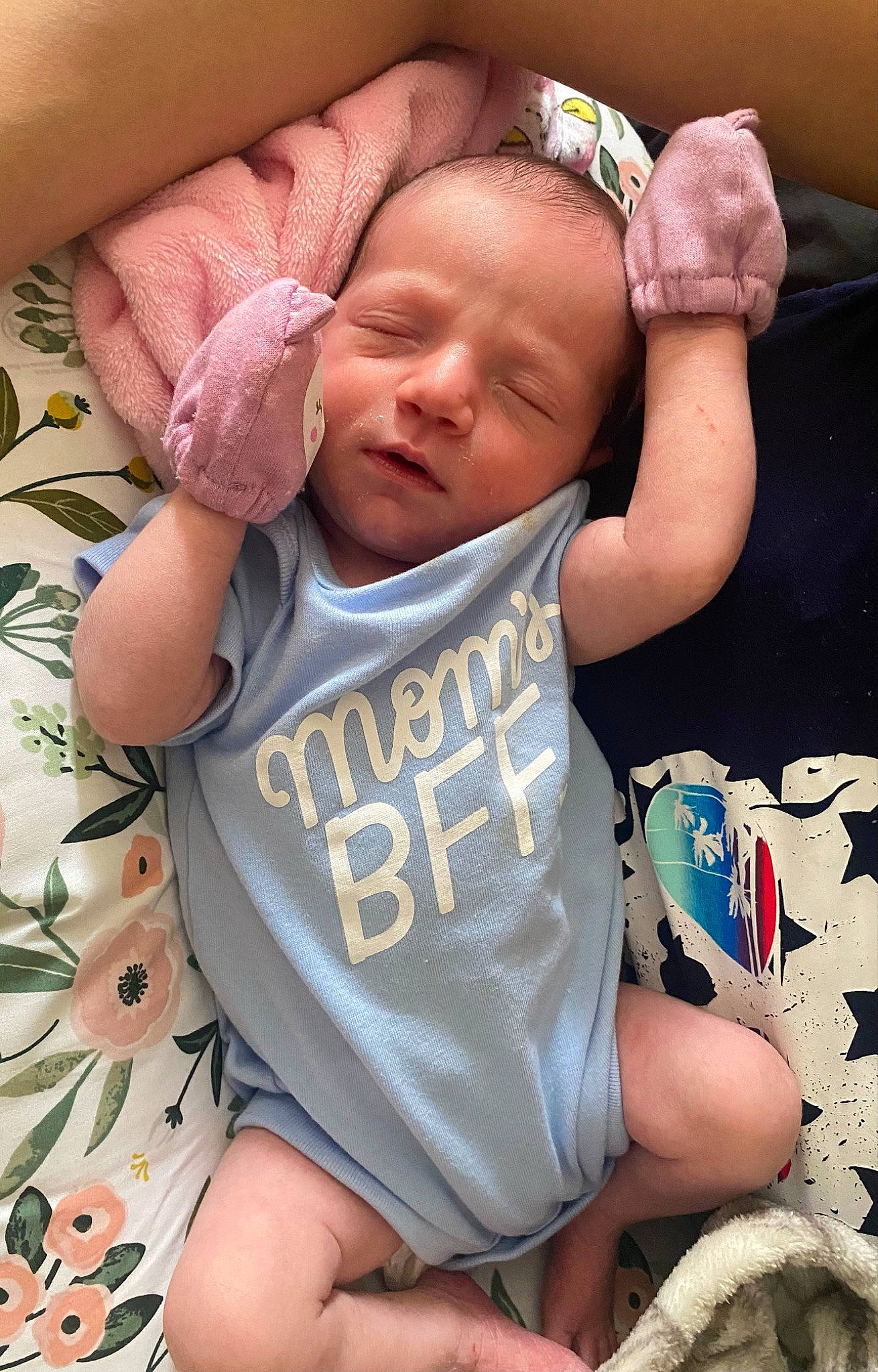 Mikaela is registered to the contest to win money with this photo: arm, baby, baby_toddler_clothing, cheek, comfort, eye, face, finger, hand, happy, head, human_body, joint, mouth, neck, person, pink, skin, sleeve, textile