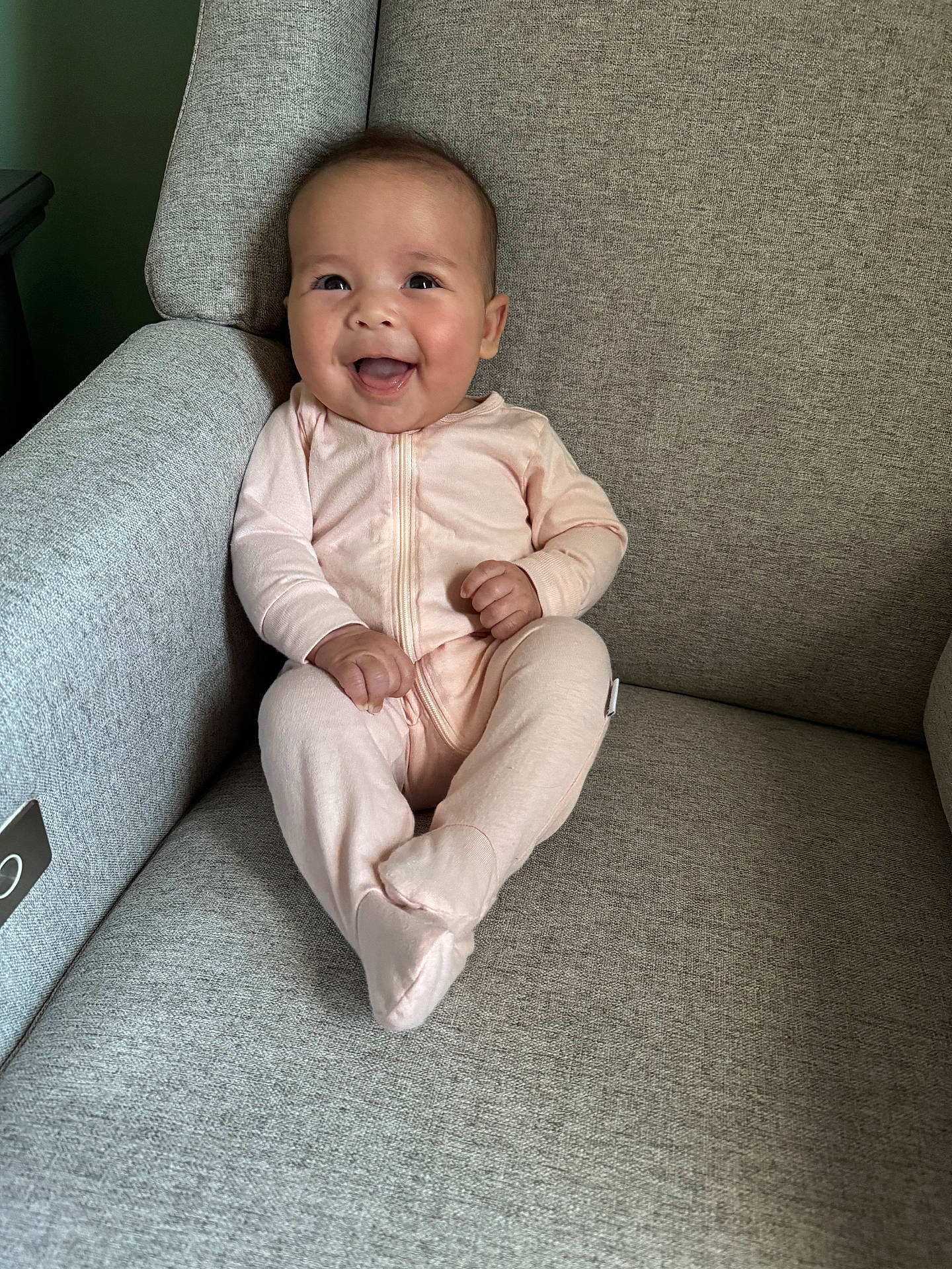 Mackenzie is registered to the contest to win money with this photo: armchair, baby, babylaughing, chair, clothing, couch, cushion, face, furniture, happy, head, homedecor, laughing, pajamas, pants, person, photography, portrait, sitting, smile