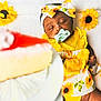 Rayneris joined the competition — help win amazing prizes! baby, sleeping, headband, yellow_clothing, sunflower_pattern, pacifier, blanket, cake, food, plate, infant, cute, soft_texture, resting, child, sweet, celebration, bright_colors, adorable, indoor