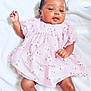 Rayneris is registered to the contest to win money with this photo: baby, infant, child, dress, pink_dress, floral_pattern, white_blanket, sock, cute, smiling, lying_down, skin, face, hand, foot, soft_texture, indoors, portrait, happy, adorable