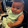 baby, child, high_chair, bib, blanket, drool, indoor, restaurant, diner, floor_tiles, person, curious, seat, table, window, casual_clothing, face, skin, arm, hair