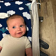 Theodore joined the competition — help win amazing prizes! baby, infant, crib, blanket, cloud_pattern, pacifier, baby_lotion, flooring, wood_floor, mesh_side, baby_garment, smiling, blue, white, person, child, lying_down, indoors, cute, expression