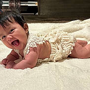 Annette joined the competition — help win amazing prizes! baby, blanket, cheerful, child, clothing, cozy, crawling, cute, face, happy, indoors, infant, lying_down, newborn, portrait, skin, smiling, soft, toddler, white