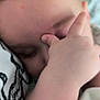 baby, child, hand, face, sleeping, close_up, blanket, skin, infant, comfort, soft, cute, young, chubby_hand, peaceful, indoors, portrait, resting, cozy, human
