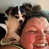 Gizmo joined the competition — help win amazing prizes! person, dog, smiling, face, shoulder, curly_hair, pet, closeup, indoor, cute, companion, happy, fur, black_and_white_dog, skin, nose, eyes, cheeks, laying_down, friendly