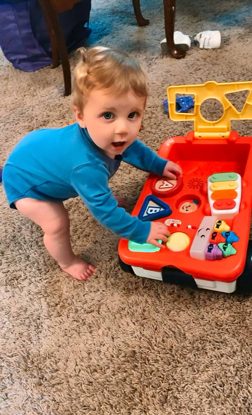 Lucas is registered to the contest to win money with this photo: baby, baby_playing_with_toys, baby_products, baby_toddler_clothing, baby_toys, child, flooring, fun, grass, leisure, person, plastic, play, recreation, sharing, sitting, smile, soil, surprise, toddler