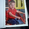Néo participe au concours pour gagner de l'argent avec cette photo : child, boy, smile, playground, slide, tricycle, red_shirt, navy_shorts, outdoor, daylight, happy, play_equipment, photograph, park, seat, handlebars, toy, fun, young, portrait