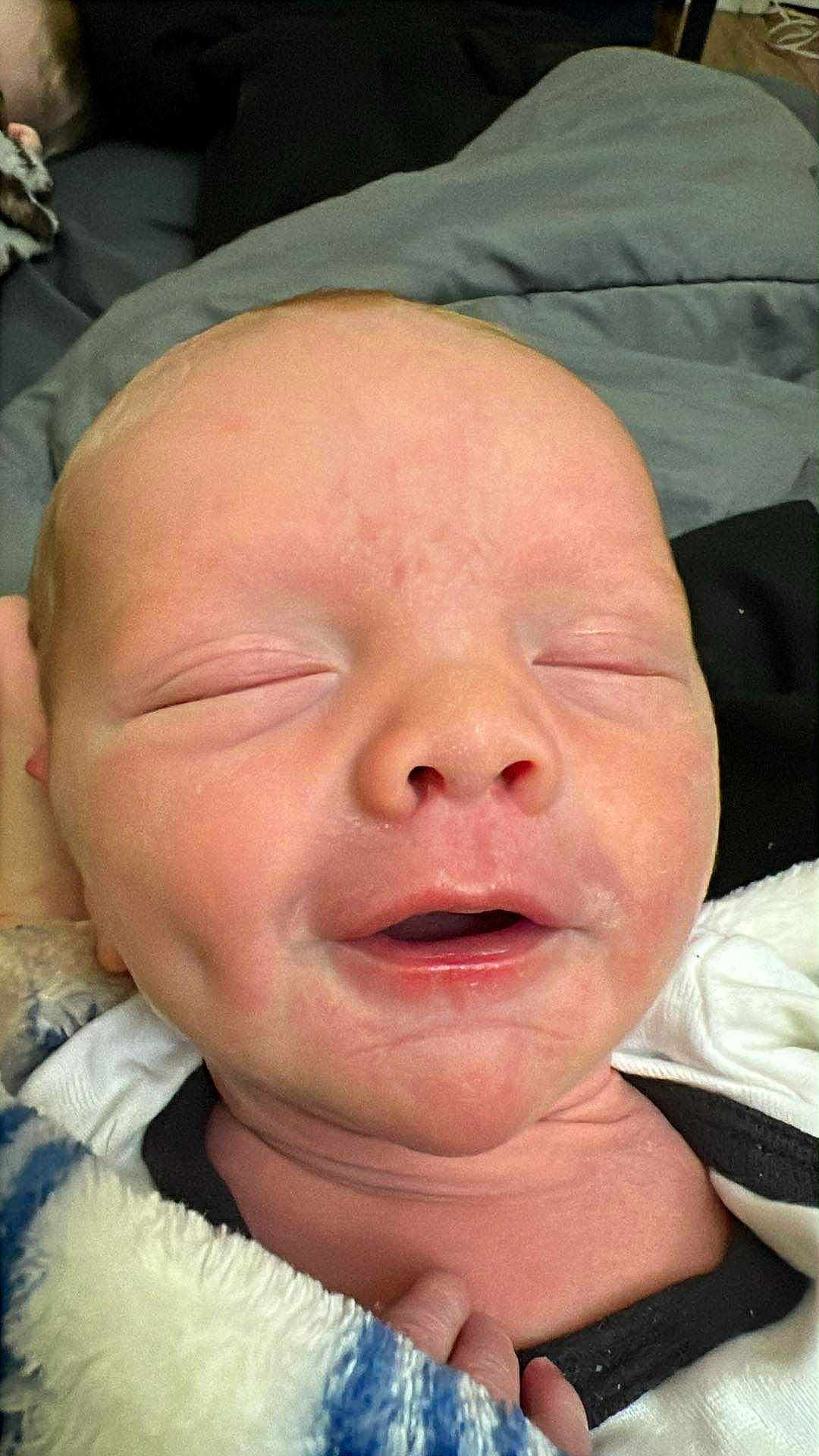 Zane joined the competition — help win amazing prizes! baby, newborn, close_up, face, skin, blanket, infant, sleeping, mouth_open, head, portrait, cozy, soft, cute, person, human, child, newborn_baby, indoors, resting