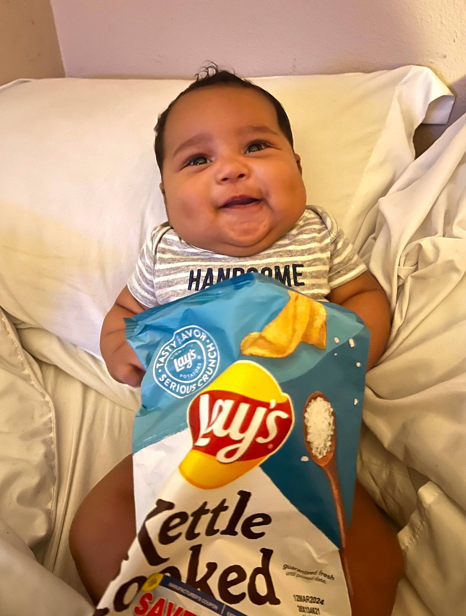 Samson is registered to the contest to win money with this photo: baby, baby_products, baby_safety, baby_sleeping, baby_toddler_clothing, child, comfort, face, finger, happy, junk_food, linens, logo, person, product, room, sleeve, smile, t_shirt, thumb