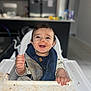 Kenai is registered to the contest to win money with this photo: baby, high_chair, messy, food, smiling, infant, bib, happy, face, hands, indoor, kitchen, child, cute, mess, feeding, young, portrait, playful, home