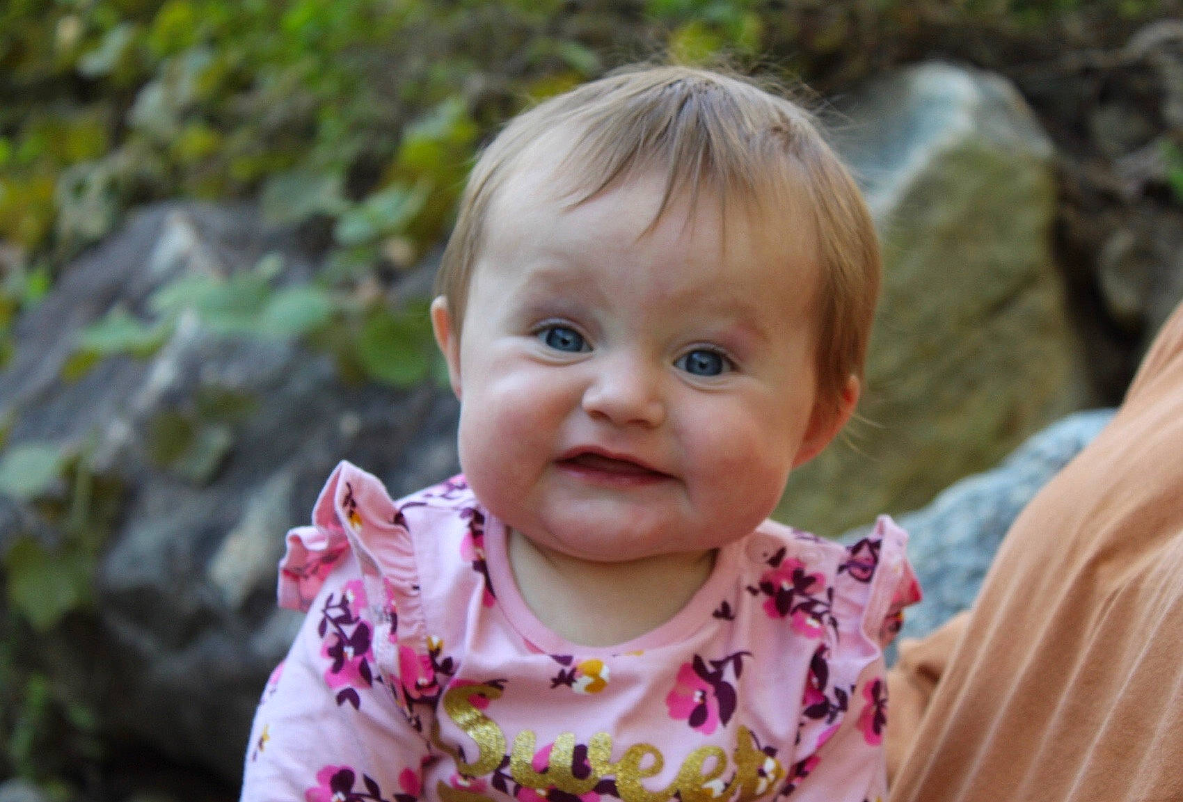 Madisyn is registered to the contest to win money with this photo: baby, cheek, child, eye, face, grass, happy, head, iris, lip, person, pink, plant, skin, smile, toddler, vacation