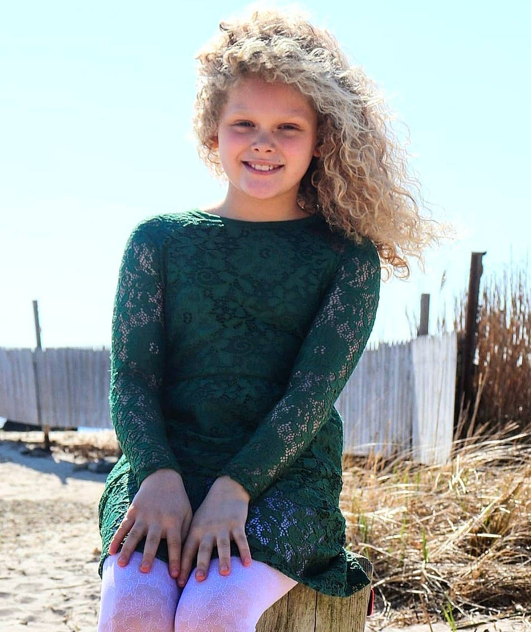 Elizabeth is registered to the contest to win money with this photo: clothing, dress, face, fashion_design, fawn, flash_photography, grass, hair, hairstyle, happy, head, joy, knee, person, plant, shoulder, sky, sleeve, smile, street_fashion