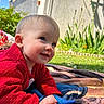 baby, child, smiling, red_sweater, blanket, outdoor, grass, flowers, garden, face, blue_eyes, skin, hand, crawling, daylight, sunny, person, head, happy, nature