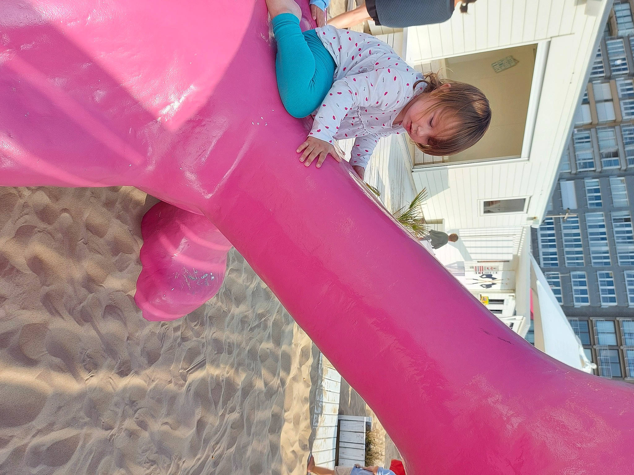 Victoire participe au concours pour gagner de l'argent avec cette photo : blue, building, chute, city, fun, human_leg, leisure, magenta, outdoor_play_equipment, person, photograph, pink, playground, playground_slide, recreation, red, sky, thigh, toddler, tree