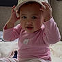 Reese is registered to the contest to win money with this photo: baby, child, hat, pink_clothing, striped, indoor, blanket, window, cute, smiling, face, hands, sitting, infant, cozy, soft_lighting, portrait, person, cute_baby, playful
